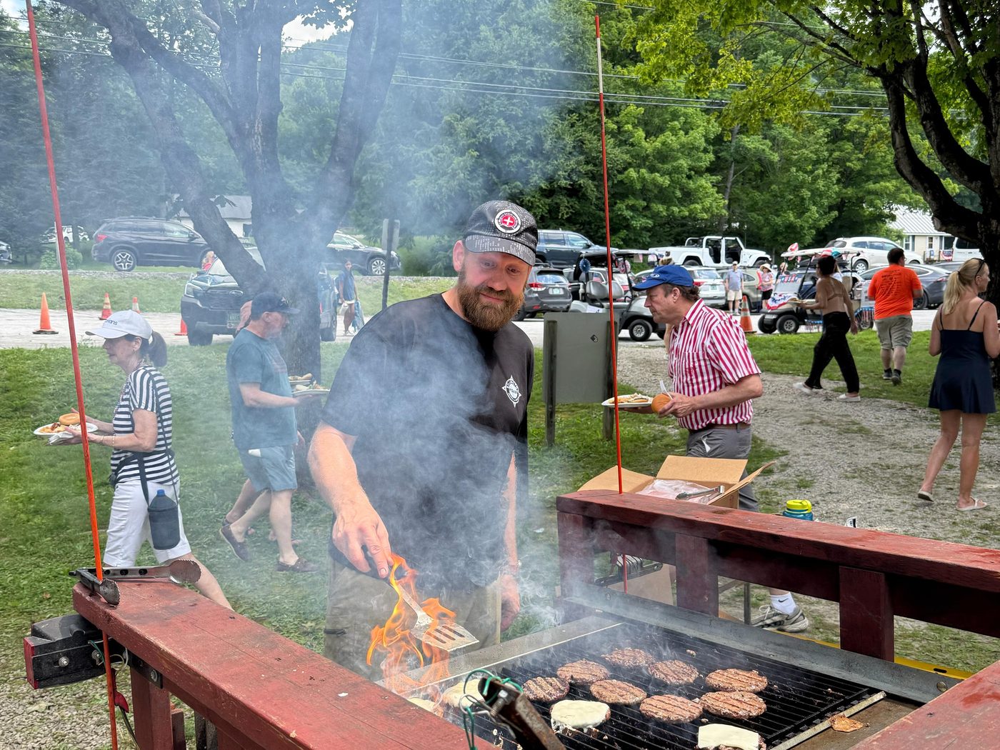 A KSAR member grills burgers at a community cookout
