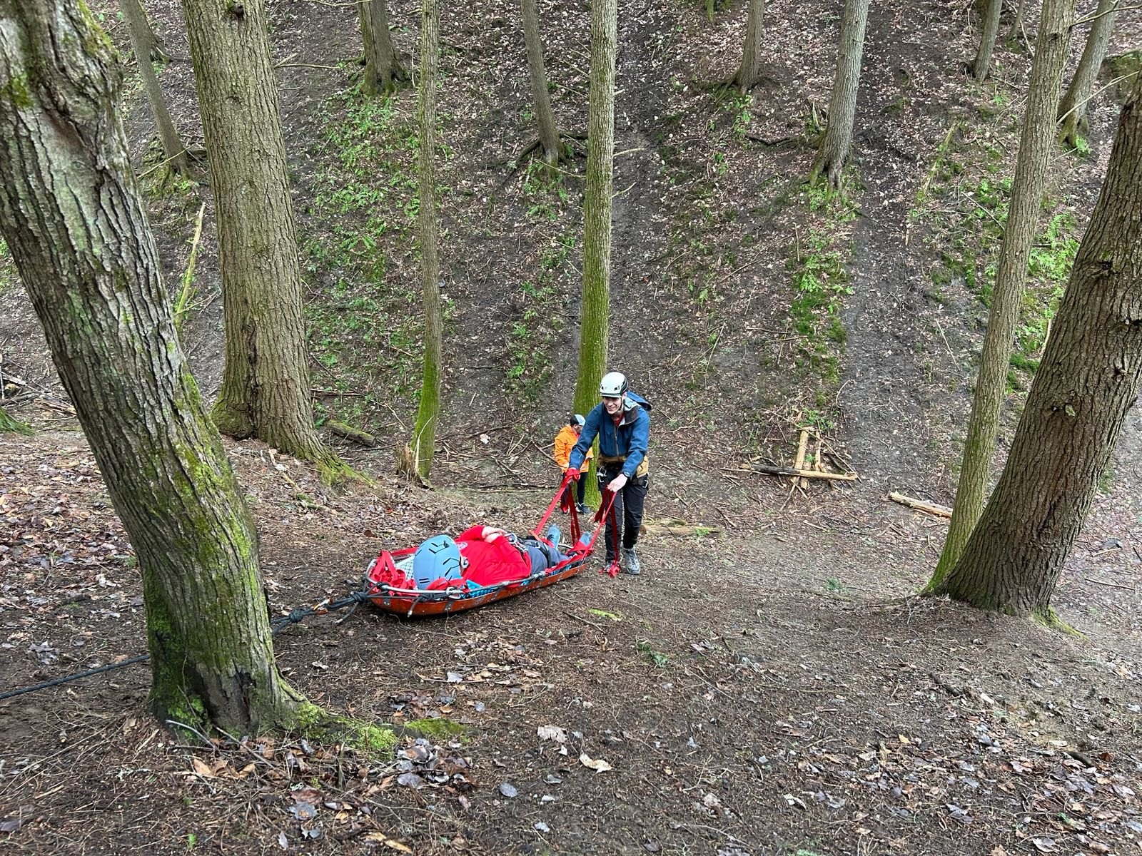 A KSAR member hauls a litter on rope rigging during training